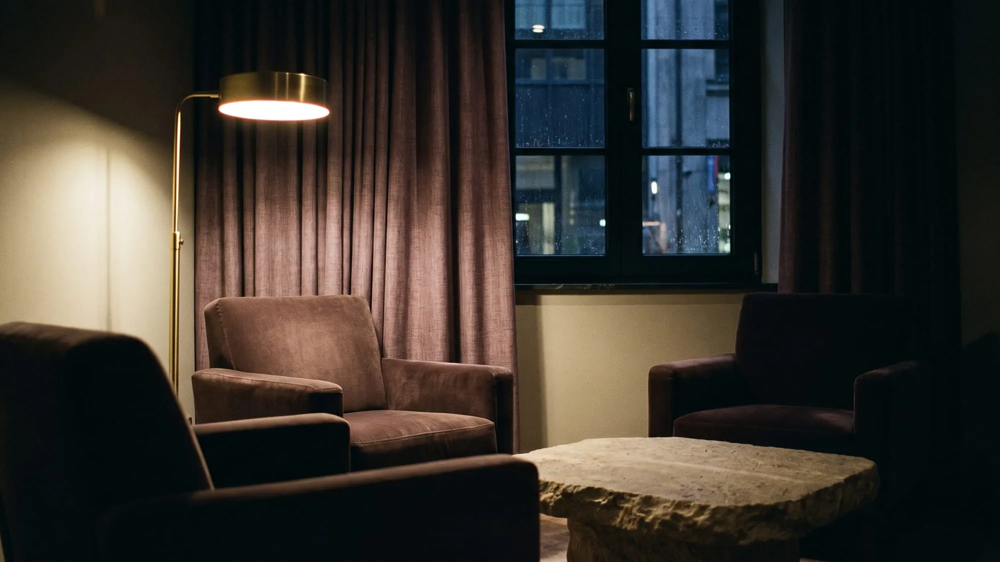 Two chairs and a lamp in the consulting room at the end of the day